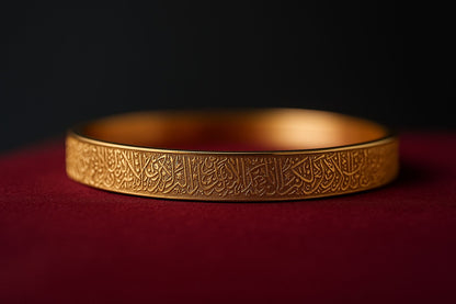 Gold bracelet with intricate designs on a dark background