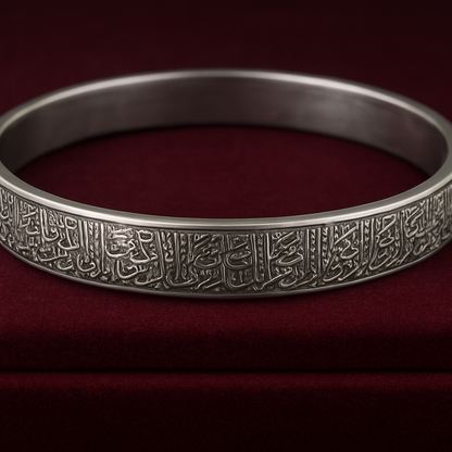 Silver bracelet with intricate designs on a red background